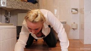 Frida cleaning the bathroom in her white shirt and black glossy leggins