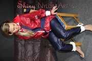 Sexy Sandra wearing sexy red/blue rainwear being tied and gagged with ropes and a clothgag on a chair (Pics)