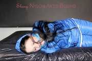 Lucy wearing sexy lightblue downwear tied and gagged with ropes and cloth gag on a bed (Pics)