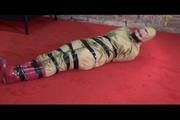 Jill tied, gagged and hooded lying on the floor wearing sexy shiny nylon golden rainwear (Video)