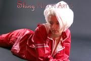 Blonde archive girl posing in a studio wearing a sexy red AGU rainwear combination (Pics)