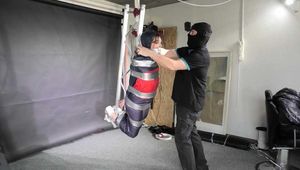 Marie taped and suspended in shiny nylon Rainwear