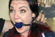Jill tied and gagged on a sofa wearing a shiny nylon shorts and a rain jacket (Pics)