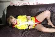 Sexy Lucy tied an gagged with ropes and a cloth gag wearing a super hot red shiny nylon shorts and a yellow rain jacket (Pics)