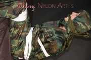 Sexy PIA being tied and gagged with tape and a clothgag on the sofa wearing a camouflage rainsuit and yellow rubber boots (Pics)