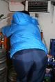 Jill posing in a cooling room wearing a shiny nylon rainpants and a down jacket (Pics)