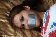 Roxana hogtied on bed