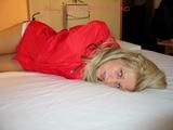 Beautiful archive girl tied and gagged on a bed wearing shiny shorts (Pics)
