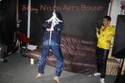 Sandra beeing tied and gagged by Stella in Shiny Nylon Rainwear crotchrope-suspended 