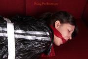 Alina tied and gagged in a shiny black PVC sauna suit
