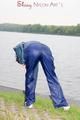 Sexy archive girl wearing a blue rain pant and rain jacket walking on a lake in freetime (Pics)