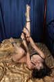 Jessica in polka dot bra and panties, cuffed with steel cuffs on her hands and ankles, poses and stimulates herself