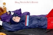 Jill tied and gagged in shiny nylon rainware