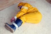 Katharina tied and gagged in a yellow rainsuit