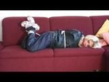 03:06 Min. video with Nina tied in a blue nylon rainsuit