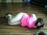 Sandra hogtied on the floor