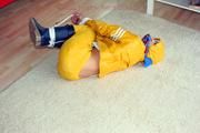 Katharina tied and gagged in a yellow rainsuit