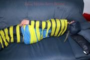 Katharina taped and gagged in a blue nylon rainsuit