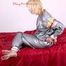 Pia tied and gagged in a shiny silver sauna suit bare feet on a bed (Pics)