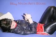 Mara ties and gagges herself with hand cuffs on a sofa wearing a supersexy black Leggings and a shiny nylon shorts and a rain jacket (Pics)