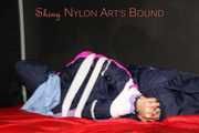 Watching Pia wearing blue/pink shiny nylon rainwear being tied and gagged and hooded with tape and a clothgag (Pics)