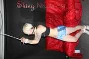 Watching ***NEW MODELL COURTNEY*** wearing a sexy lightblue shiny nylon shorts and a black top being tied and gagged overhead with ropes and a ballgag (Pics)