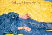 Alina wearing a sexy shiny rainwear suit in blue lolling on bed cuffed (Pics)