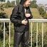 Leonie posing outdoor on a bridge wearing a sexy black shiny nylon rainwear combination (Pics)