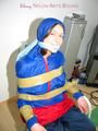 Katharina tied by using tape, gagged and hooded on a chair wearing sexy red/blue rainwear (Pics)