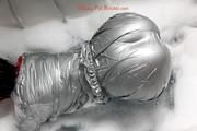 Simone in an shiny grey pvc sauna suit tied and gagged by Sophie in the bath tub (pics)