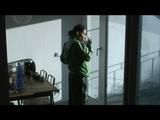 Enni with black shiny nylon shorts and rain pants and a rain jacket over naked skin smoking a cigarette (Video)