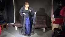 Watching sexy Sandra wearing a supersexy long rainwear skirt trying on several rain coats with hoods (Video)