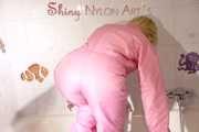 Sonja wearing a sexy pink down suit playing with the foam in her bath tub and enjoying the feeling in the wet clothes (Pics)