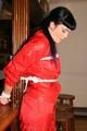 Jill bound in a red nylon rainsuit