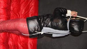 Watching Pia wearing a supershiny crazy sensation downsuit and jacket in black and red being tied and gagged overhead with ropes and a clothgag (Pics)