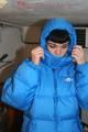 Jill posing in a cooling room wearing a shiny nylon rainpants and a down jacket (Pics)