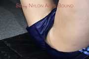Watching sexy Pia wearing a sexy blue oldschool shiny nylon shorts and a rain jacket being tied and gagged on hands and feet on the ceiling lying on the floor (Pics)