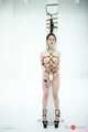 Kinbaku waitress in shiny metal