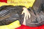 Lucy preparing her bed and enjoys it wearing sexy black rainwear (Pics)