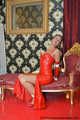 Miss Scarlett bound and gagged in a long red Latex dress