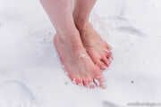 Katrin barefoot in the snow.