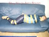 Leoni tied, gagged and hooded with tape wearing a sexy blue rainwear combination (Pics)