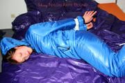Alina tied and gagged in a shiny skisuit