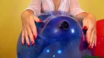 red fingernail popping of seven balloons