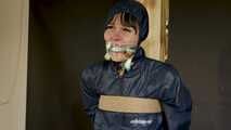 Lana tied and gagged and gagged to Post in shiny nylon Rainwear
