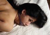 Nude barefoot ballgagged Alberta, hogtied with her elbows tightly bound together, wiggles and rolls on the bed