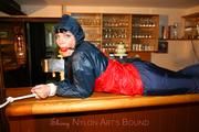 Jill tied and gagged in shiny rainwear