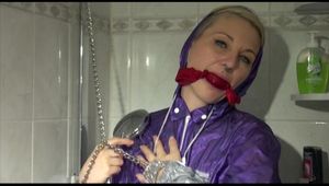 Mara tied, gagged and hooded in a shower wearing a sexy purple rain combination (Video)