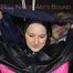 Sexy Mara tied, gagged and hooded overhead on hands and feet with ropes and a cloth gag wearing a sexy black/pink rainwear combination (Pics)