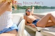 Stella and Leonie on a boat wearing sexy shiny nylon shorts and bikini tops (Pics)